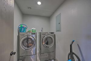 a laundry room with two washing machines in it at Le Bleu, Bright Hodgen Home with Fire Pit and Views! in Hodgen