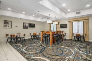 a room with a table and chairs on a rug at Best Western Plus Silvercreek Inn in Swansboro