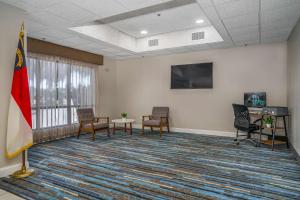 a large room with chairs and a flag in it at Best Western Plus Silvercreek Inn in Swansboro