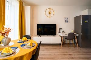 a living room with a table with a yellow table cloth at DN Blue Apartment in Budapest