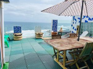 tavolo e sedie con ombrellone e oceano di Atico de la Pardela a La Laguna
