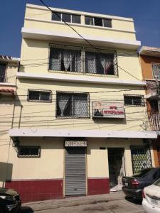 a building with curtains in the windows of it at Hotel Metropolitano in Guatemala