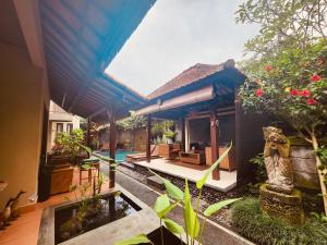 a villa with a pool and a house at Uma Padi Villa in Ubud