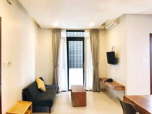 a living room with a black chair and a television at Ptas Tauch Residence in Phnom Penh