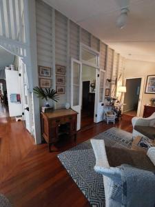 a living room with a couch and a table at Charming Queeenslander in City Centre in Cairns
