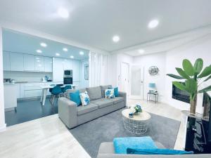 a living room with a couch and a table at Central Tiled Apartment in Aveiro