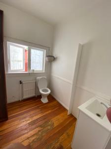 a bathroom with a white toilet and a sink at Young Hostel in Rotorua