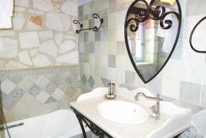 a bathroom with a sink and a mirror and a tub at Ira Agios Leon Zakynthos in Agios Leon