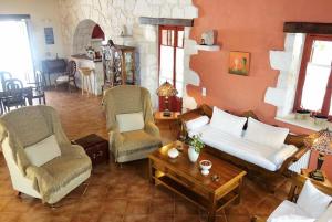 a living room with a couch and chairs and a table at Ira Agios Leon Zakynthos in Agios Leon