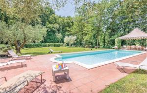 a swimming pool in a yard with chairs and a table at Villa Luna in Vitorchiano +18 photos