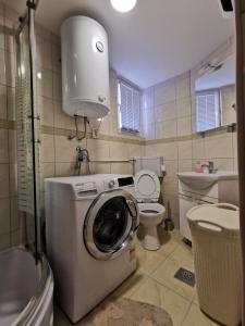 a bathroom with a washing machine and a toilet at Seaside holiday house Luka, Dugi otok - 20212 in Sali