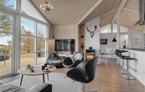 sala de estar con sillas negras y mesa en 3 Bedroom Gorgeous Home In Hadsund, en Hadsund