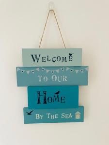 a sign that says welcome to our home by the sea at Harbour View Killybegs in Killybegs