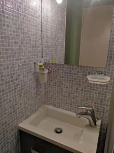 a bathroom with a sink and a mirror at Super-cute colourful, cozy flat in Saint-Raphaël