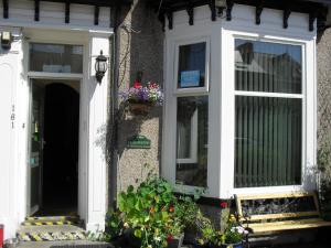 a house with a door and a window with flowers at Brafferton Guest House in Hartlepool