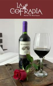 a bottle of red wine next to a glass of wine at Hotel La Cofradía in Zacatlán +9 photos