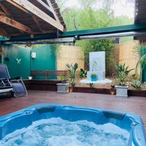 a large blue hot tub sitting in a patio at Trawool Shed Cottages, Cafe and Restaurant in Seymour