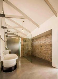 a large bathroom with a tub and a sink at Bromley Loft in Port Alfred