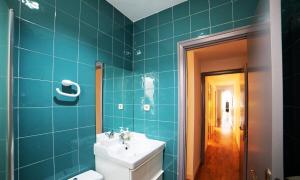 マドリードにあるMyHouseSpain - Bright apartment in Historical City Centerの青いタイル張りの壁、洗面台付きのバスルーム