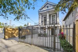 a gate in front of a house at Historic Cottage 3 mins to the French Qtr. Sleeps 12 in New Orleans