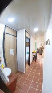 a bathroom with a toilet and a sink in a room at Apartahotel El Mirador in Zapatoca