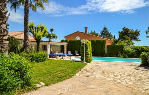 a villa with a swimming pool and a house at Beautiful Apartment In Pignan With Heated Swimming Pool in Pignan