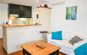 a living room with a white couch and a table at Beautiful Apartment In Pignan With Heated Swimming Pool in Pignan