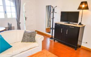 a living room with a couch and a flat screen tv at Beautiful Apartment In Pignan With Heated Swimming Pool in Pignan