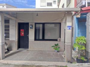 an entrance to a building with a blue door at Humble Room in Hualien City