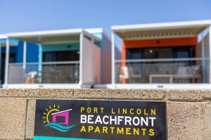 a sign on a wall in front of a building at Port Lincoln Beachfront Apartments in Port Lincoln