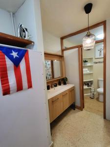 Baño con bandera americana en la pared en Bee Inn Puerto Rico Charming Urban Apartment in San Juan en San Juan