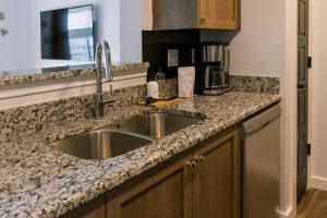 a kitchen with a sink and a counter top at Unit 222 - The Lyndon 1 Bed - Cation on the Guadalupe in New Braunfels