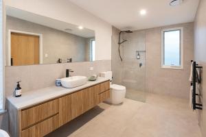 a bathroom with a sink and a toilet and a mirror at Stunning coastal home 5 bed amazing ocean views in Dunsborough +29 photos