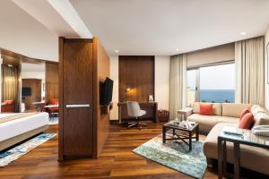 a living room with a couch and a table at Welcomhotel by ITC Hotels, Devee Grand Bay, Visakhapatnam in Visakhapatnam