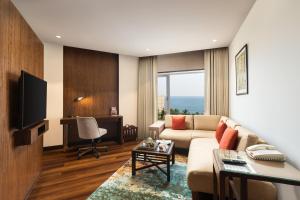 a living room with a couch and a table at Welcomhotel by ITC Hotels, Devee Grand Bay, Visakhapatnam in Visakhapatnam