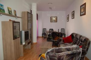 a living room with two couches and a tv at Apartamentos Santa Barbara II in Santa Bárbara