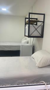 Una cama o camas en una habitación de POUSADA FLOR DO CARIBE