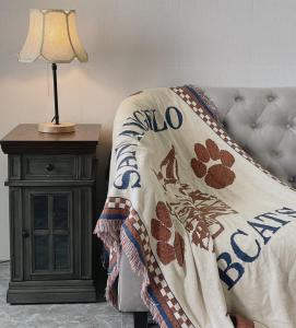 a bed with a blanket and a lamp on a table at THE URBAN CONCEPT in Liên Trì (4)