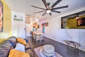a living room with a couch and a ceiling fan at Parker Studio with Patio and Direct River Access! in Parker