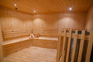a wooden sauna with a teddy bear sitting in it at Welcomhotel by ITC Hotels, Devee Grand Bay, Visakhapatnam in Visakhapatnam