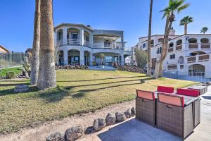 a large white house with palm trees in front of it at Spacious Parker House on the Colorado River! in Parker