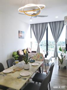 a dining room with a table and a couch at Hanns&FreeWiFi&Washer&Parking &Pool&Sauna&Sunshine Comfort Homstay2 in Sibu