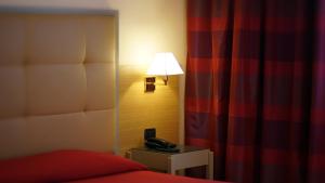 Postel nebo postele na pokoji v ubytování Garden Hotel