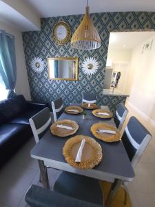 a dining room with a blue table and chairs at Summer Breeze Villa in Lucea