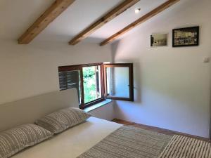 a bedroom with a bed and a window at Apartments Luki - great view in Smergo