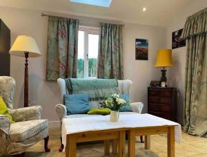 a living room with a couch and a coffee table at Countryside in the Town. in Harlescott