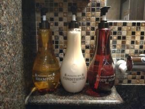 three bottles sitting on a counter in a bathroom at Dormy Inn Premium Kyoto Ekimae Natural Hot Spring in Kyoto