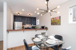 a dining room with a glass table and chairs at Comfort, Style, Short Walk to Town Park & Gondola condo in Telluride