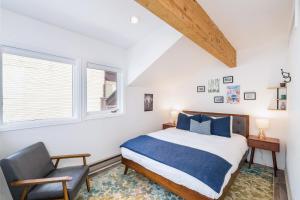 a bedroom with a bed and a chair at Comfort, Style, Short Walk to Town Park & Gondola condo in Telluride