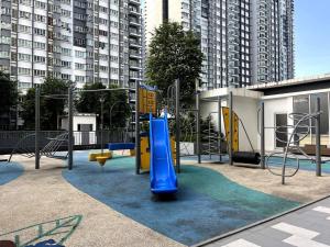 a playground with a blue slide in a city at LUXE Blok A1 3BR Savanna Suite @ Southville Bangi in Kampong Tangkas